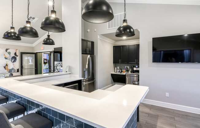 a kitchen with a long island with a white counter top at Crossgates Apartment Homes, Starkville, 39759