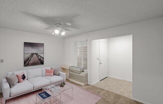 a living room with a white couch and a ceiling fanat Millcreek Woods Apartments, Olathe, 66061