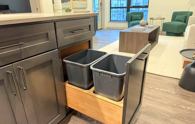 a kitchen with three storage bins in a counter top