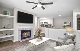 A modern living room with a fireplace and a flat screen TV.