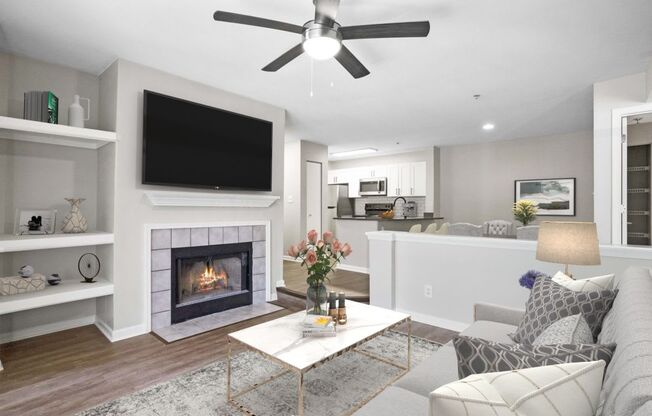 A modern living room with a fireplace and a flat screen TV.