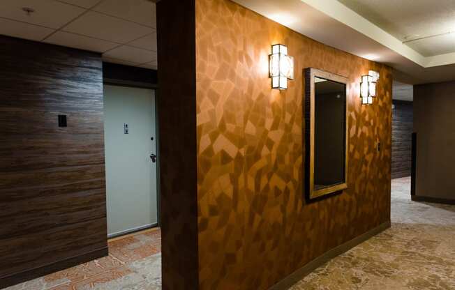 the hallway of a with a mirror on the wall at Hampton Plaza Apartments in Towson, MD 21286