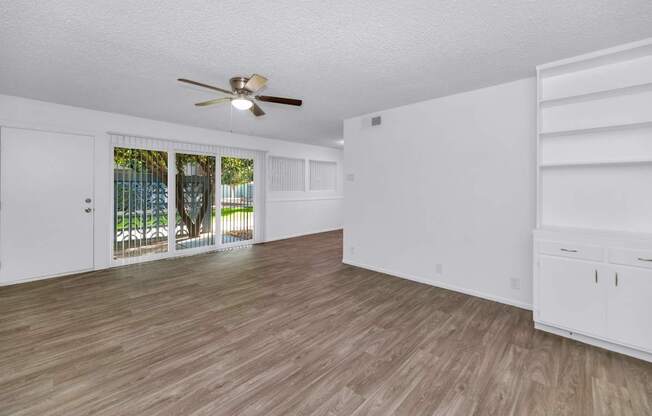 A room with a ceiling fan and wooden flooring at The Phoenix Apartments on 6th Avenue, Arizona 85013