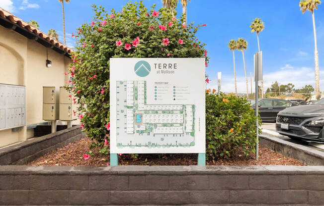A sign for Terre at Million is displayed in front of a building.