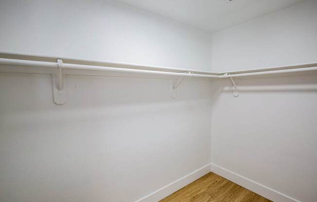 Empty room with white walls and wooden floor.