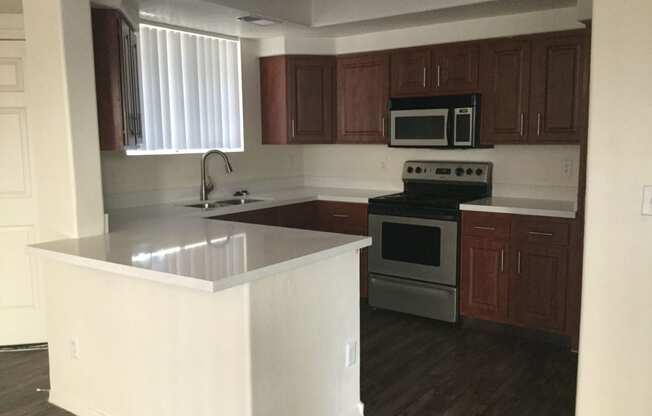 an empty kitchen with an island in the middle of it