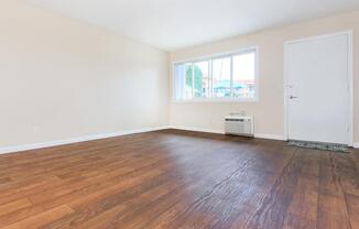 a large empty room with a wood floor