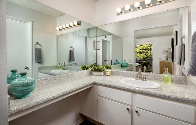 A bathroom with a sink, mirror, and lights.