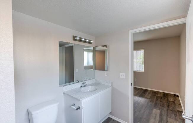 an empty bathroom with a mirror and a toilet