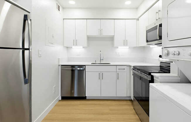 Kitchen with Stainless Steel Appliances and In-home Washer and Dryer