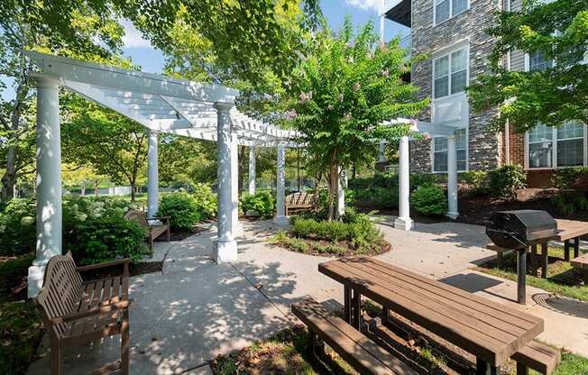 a courtyard with benches and a pergola