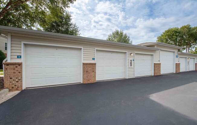 A row of garage doors are closed and lined up in a row.