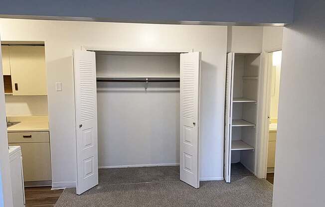 A dining room with a closet with a shelf and a linen closet at Waverly Park Apartments, Lansing