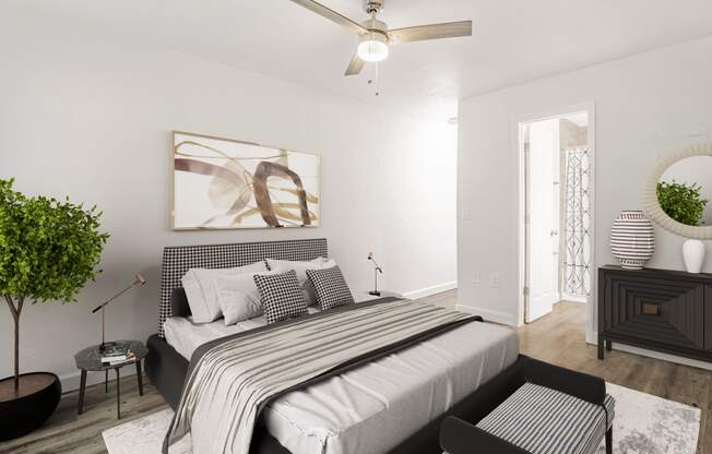 a bedroom with a bed and a ceiling fan