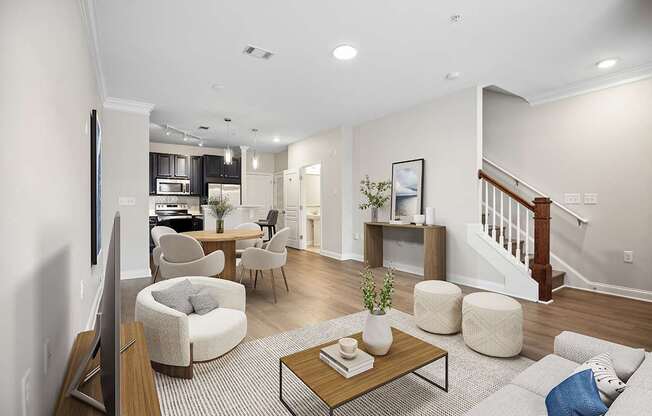 A living room with a couch, chairs, and a coffee table.