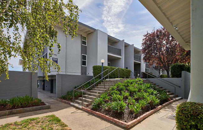A modern building with a staircase leading to the entrance.