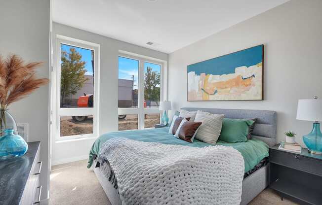 a bedroom with a large bed and a large window