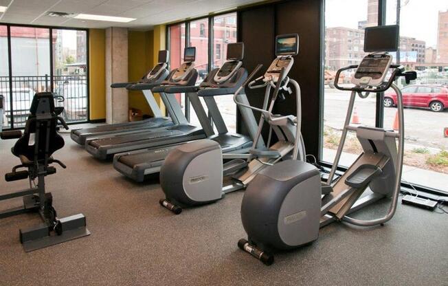 A gym with treadmills and elliptical machines.