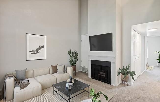 Model Living Room with Carpet and Fireplace at Broadmoor Village Apartments in Salt Lake City, UT.