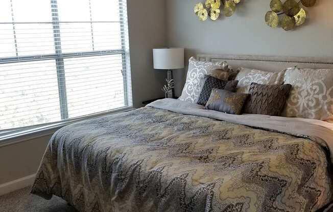 a bedroom with a large bed and a ceiling fan