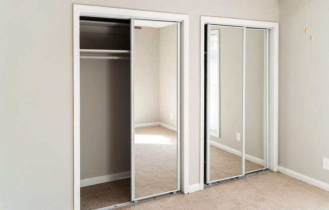 A room with a white door and a white wall.