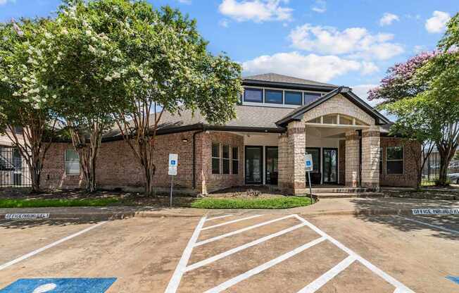 A building with a parking lot in front of it.