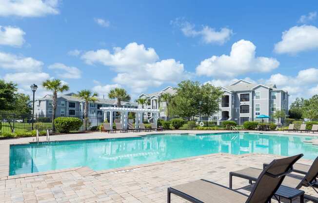 Courtney Station Apartments - Resort-style pool with pergola and seating area