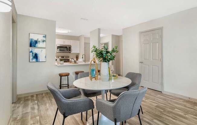 A dining room with a table and chairs.