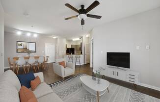 a living room with a couch and a tv at MetroPlace at Town Center, Maryland