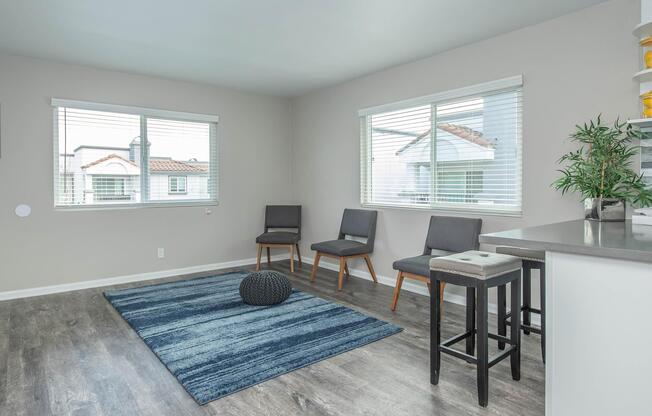 a living room filled with furniture and a large window