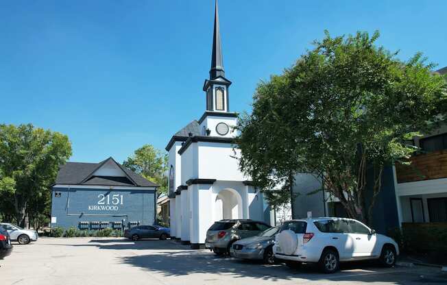 a white church with a tall steeple and a clock tower  at 2151 Kirkwood, Houston, Texas