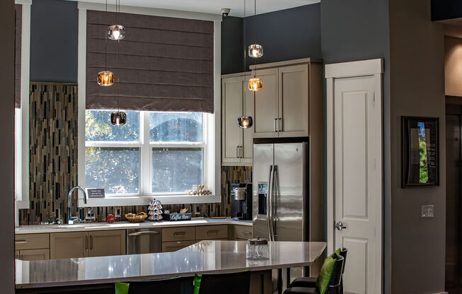 a kitchen with a large island and a refrigerator