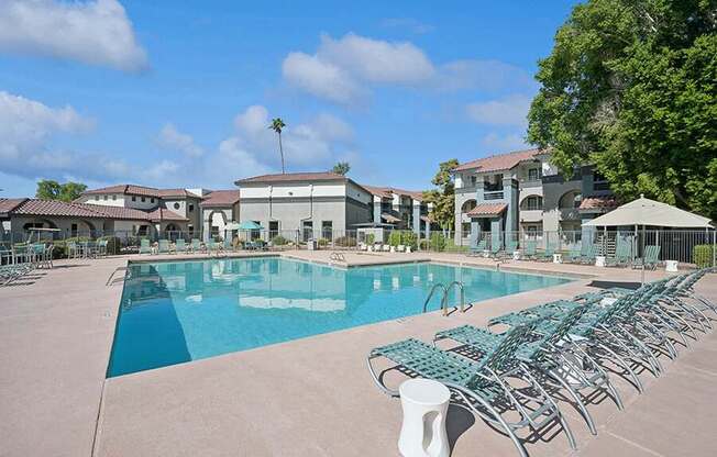 Community Swimming Pool with Pool Furniture at Stillwater Apartments located in Glendale, AZ.