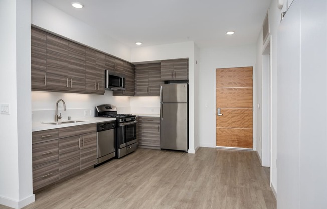 a kitchen with stainless steel appliances and wooden cabinets