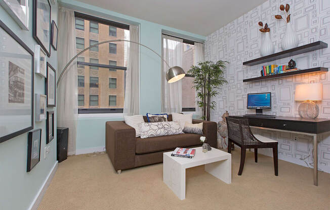 a living room with a couch and a desk