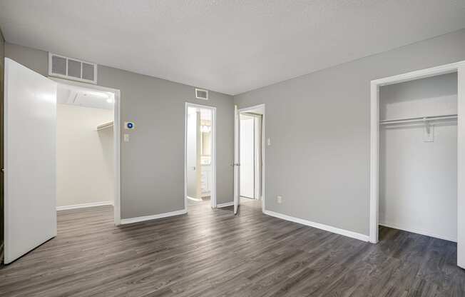 an empty living room with white walls and wood flooring