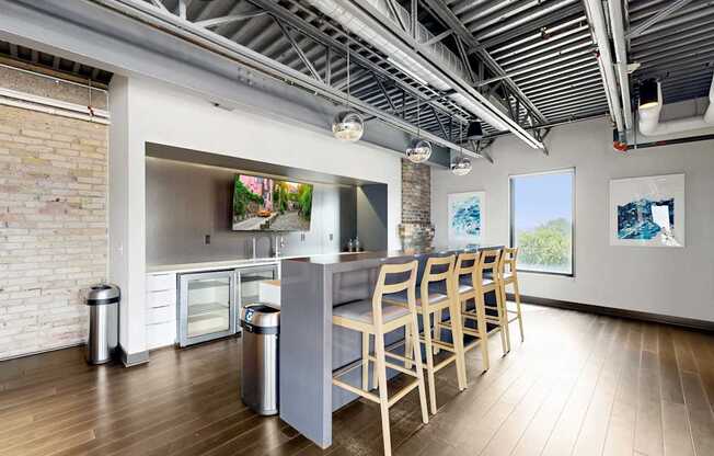 A kitchen with a long table and chairs.