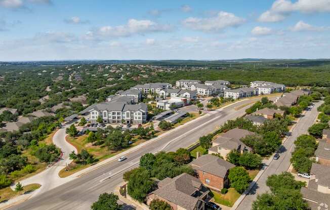 A bird's eye view of a residential area with houses and a road.