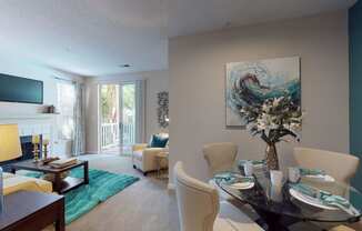 a living room with a table and chairs and a fireplace at Autumn Park Apartments, Charlotte, North Carolina