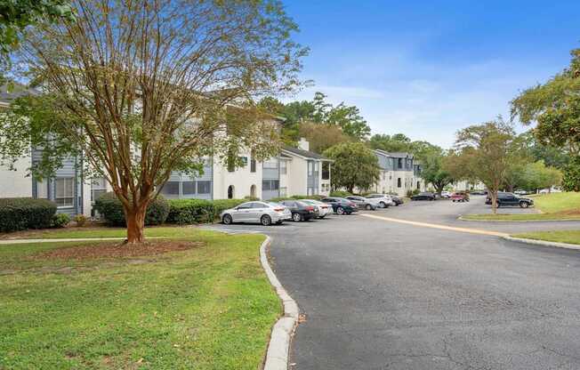 a street with houses and cars parked on the side of the road