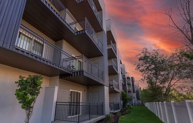 a row of apartments with balconies at sunset