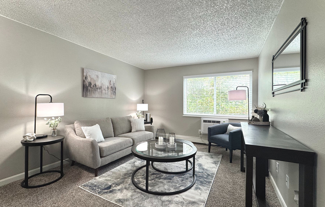 Spacious living room with natural light and stylish, modern furnishings