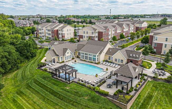 an aerial view of an apartment complex with a swimming pool