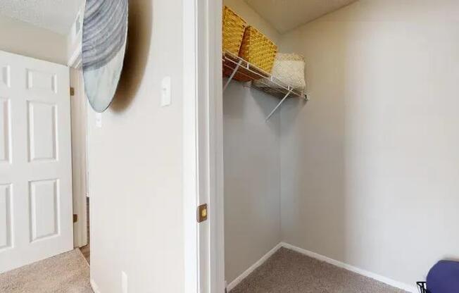 A white door is open to a room with a beige carpet.