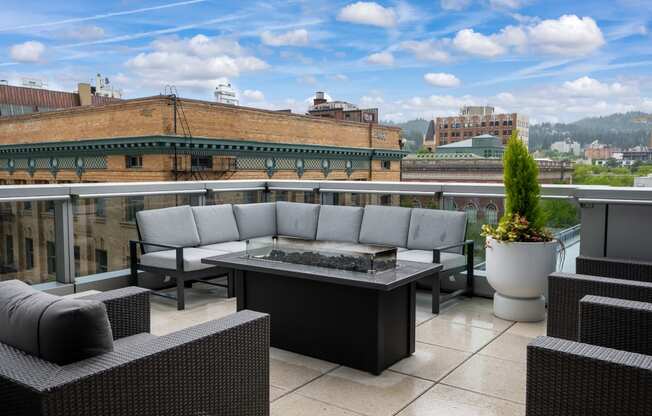 a terrace with couches and a table on a balcony