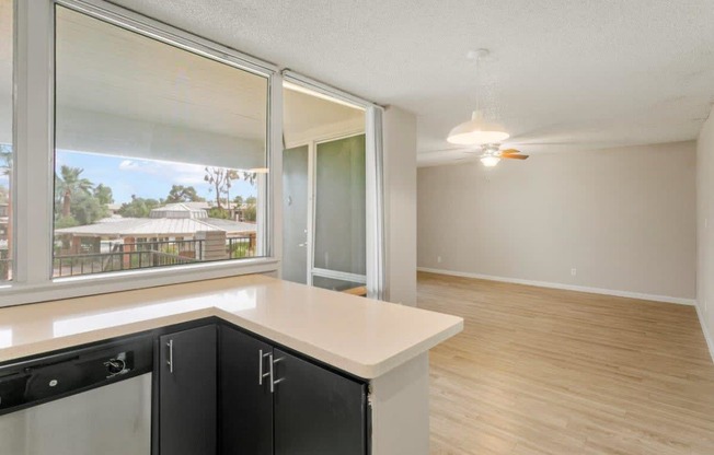 an open kitchen and living room with a large window