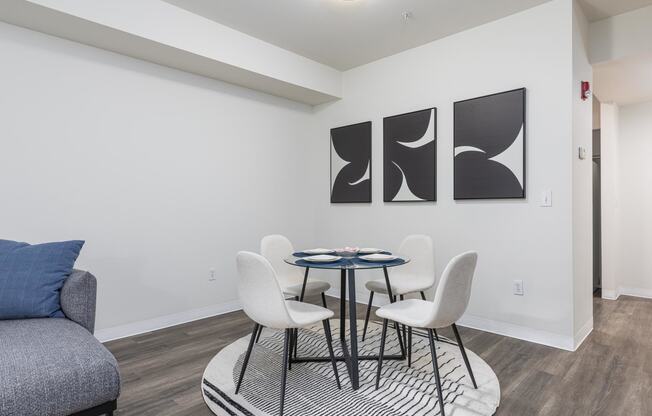 a dining room with a table and chairs and a couch  at Shoreline Village, Richland, 99352