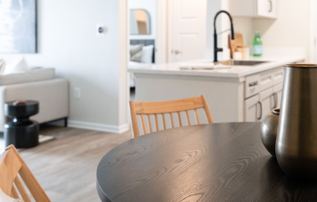 a kitchen with a wooden table and chairs