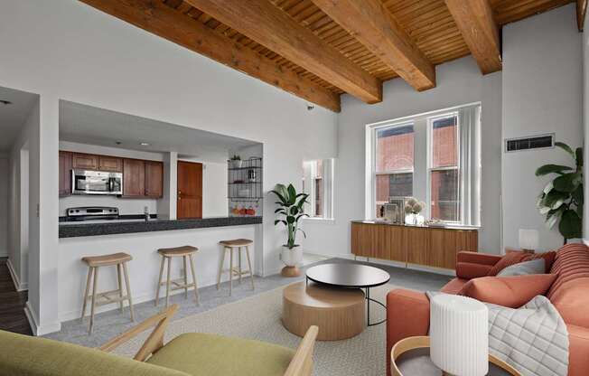 A living room with a bar area and a kitchen in the background at Lowertown Commons Apartments, Minnesota
