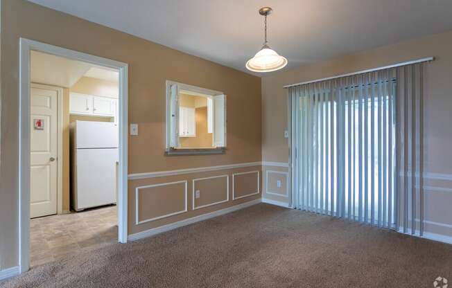 an empty living room with blinds on the window